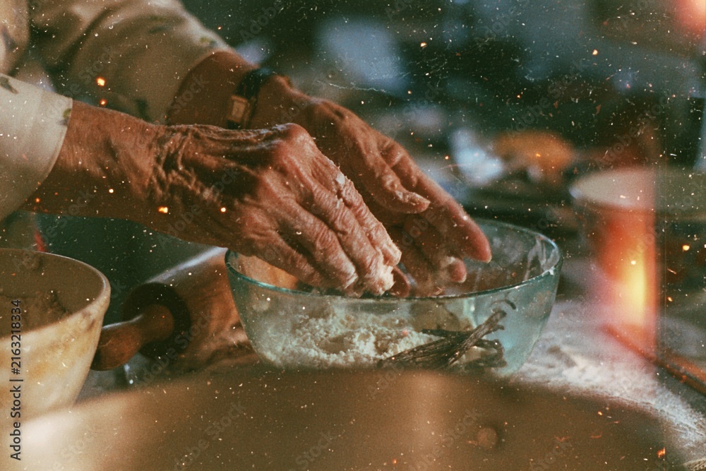 Fototapeta premium Hands kneading flour dough in glass bowl mixing ingredients baking