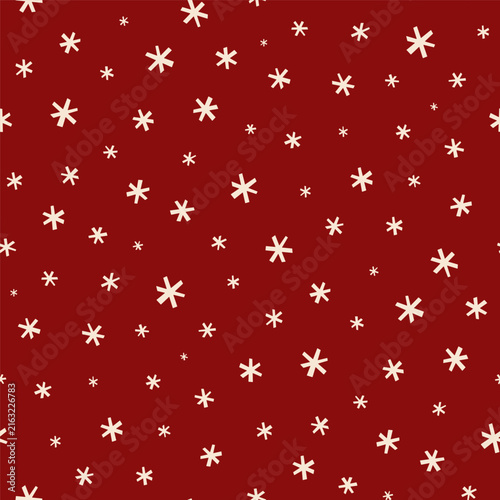 Small white snowflakes isolated on a red background. Cute seamless pattern. Vector simple flat graphic illustration, hand drawn. Texture.