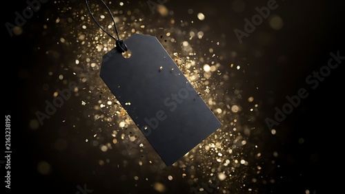 Blank black rectangular price tag hanging against a dark background, with golden glitter particles