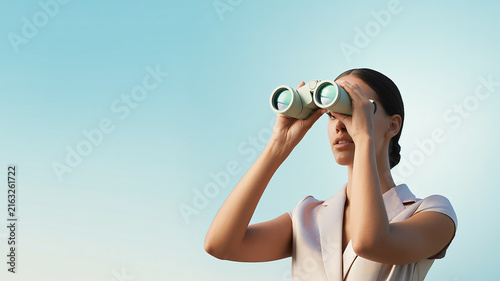 Visionary Explorer: A focused woman peers through binoculars, scanning the horizon with determination. This image symbolizes forward-thinking, exploration, and a quest for new opportunities.