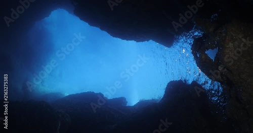blue light reflection in cave moving lights underwater ocean scenery of cave withice lightning scuba divers to explore