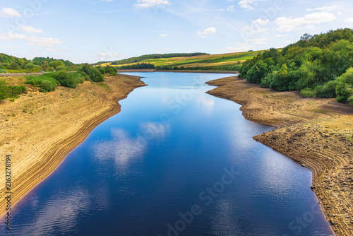 Leighton Reservoir near Masham in North Yorkshire showing exceptionally low water levels during the prolonged hot and dry summer of 2026.  The diminishing water has exposed dry banking levels