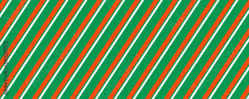 Striped candy cane Christmas seamless pattern. Red and green diagonal lines wallpaper. Winter holiday present wrapping paper. Vector gift decor backdrop. Xmas peppermint repeating background.  