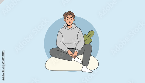 Calm man sitting cross legged in comfortable clothes meditating and relaxing on a beanbag with closed eyes.