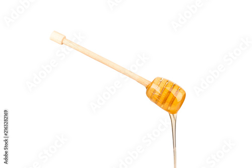 Foto Wooden dippers with golden honey isolated on white background