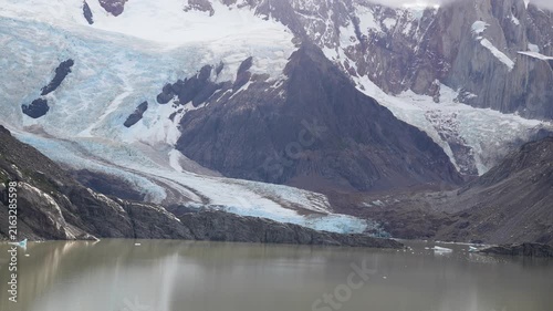 Majestic panoramic view of the Piedras Blancas Glacier in Los Glaciares National Park, Patagonia, Argentina, with its blue ice flowing into a grey glacial lake and snowy peaks