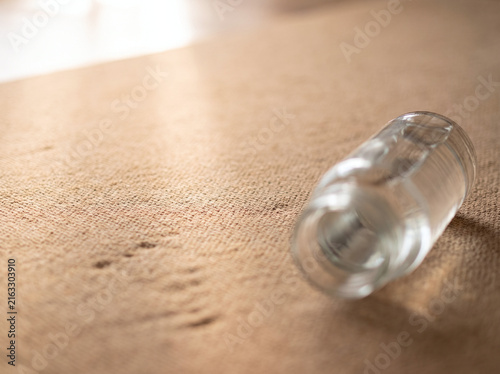 Extreme close-up of yoga mat texture with glass water bottle in soft morning light