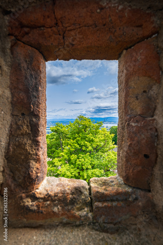 Fotografie Lush Green Forest Landscape View Framed Through Old Stone Castle Window Embrasur