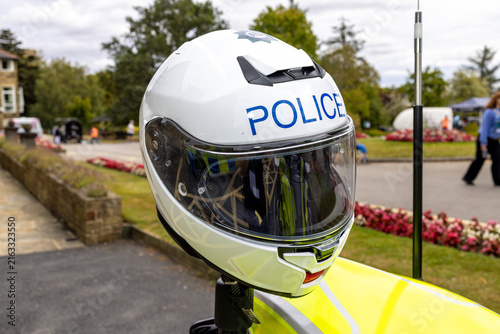 Photography Close up of a white police motorcycle helmet with clear visor and blue POLICE le