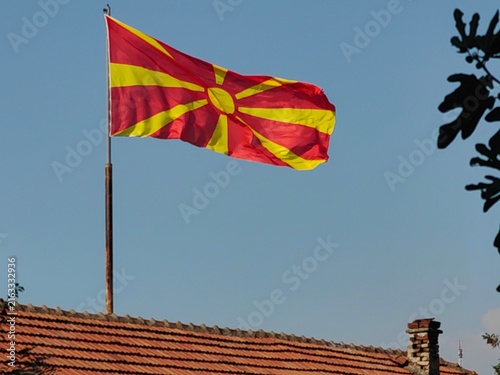 Bild auf Leinwand Macedonian Flag Over the Rooftop.