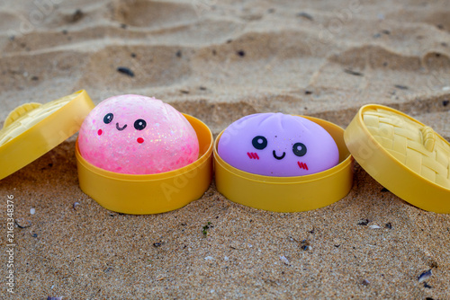 Fotografía Pink and purple kawaii dumpling toys with cute smiling faces placed inside open
