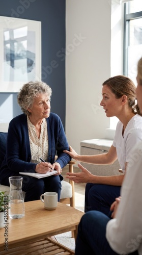 Caring Conversation Between Nurse And Senior Patient
