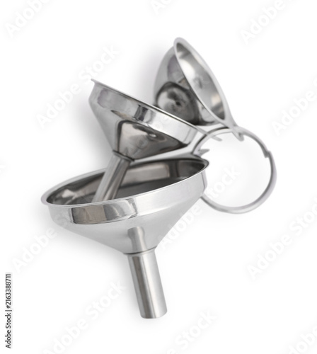 Three small metal funnels of different sizes isolated on a white