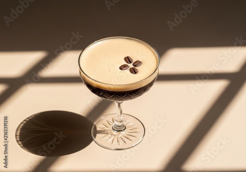 Espresso martini in crystal coupe glass with foam and coffee bean garnish. Alcoholic cocktail drink for evening refreshment and social gathering. Elegant bar beverage menu aesthetic presentation.
