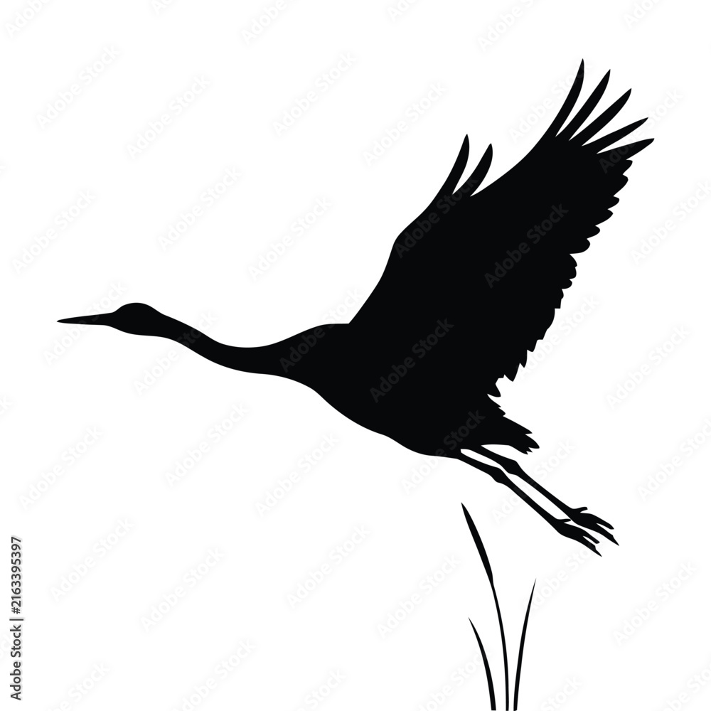 Naklejka premium A graceful crane in flight is depicted as a stark black silhouette