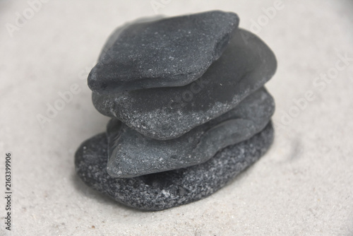 Gray Beach Glass Pile on White Sandy Shore