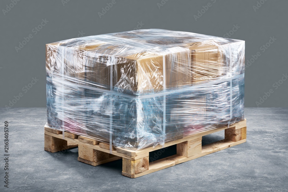Fototapeta premium Pallet Wrapped in Transparent Film Ready for International Shipping at a Warehouse
