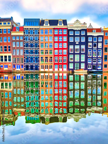 Amsterdam typical dutch houses reflected in the canal Holland, Netherlands.