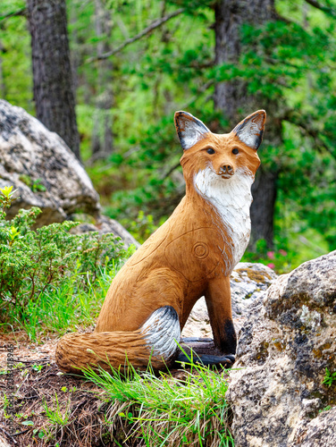 red fox wooden statue in the forest