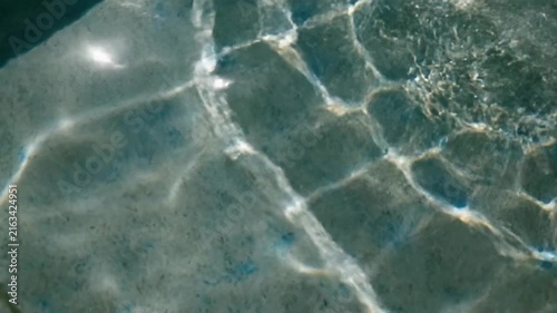 Abstract view of sunlight rippling across shallow water surfaces, creating beautiful caustic patterns, perfect for spa advertising or serene nature backgrounds, evoking calm and tranquility