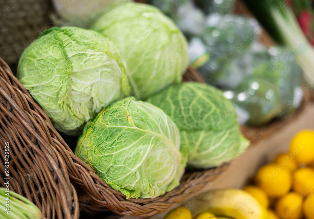 Fototapeta premium Green cabbages in supermarket, Cabbage background, Fresh cabbage from farm field, Cabbages harvest, Green cabbage for sale at farmer s market stall, heap cabbage