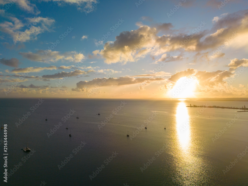 Fototapeta premium Golden sunrise over boats at Raby Bay, Queensland