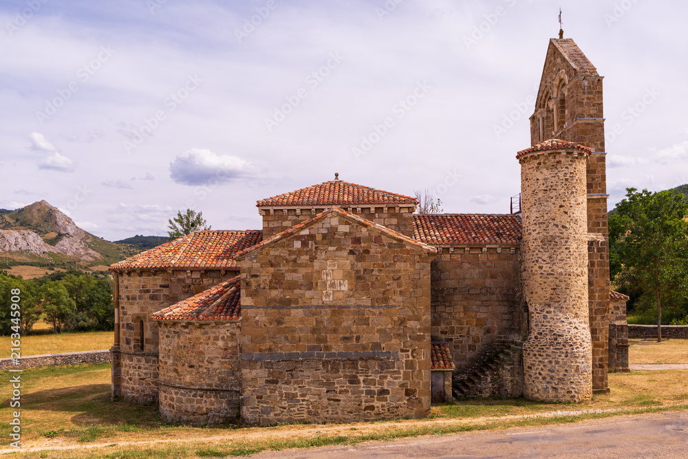 Fototapeta premium Romanesque collegiate church in north of Palencia, featuring Latin cross plan, single nave, and three semicircular apses