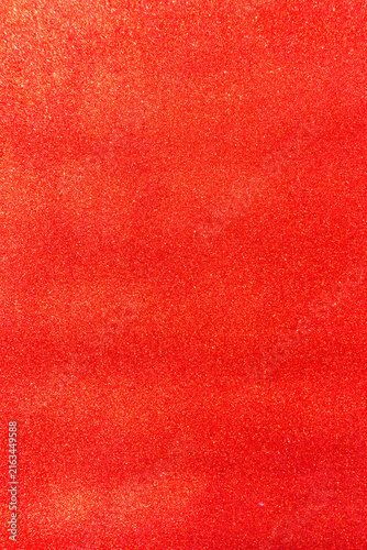 Red glitter texture creating a sparkling background, providing a vibrant backdrop for festive celebrations, holiday designs, and creative projects with a shimmering effect