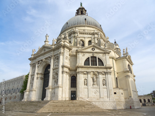 Historic baroque church with large dome and ornate white stone facade in Venice, Italy