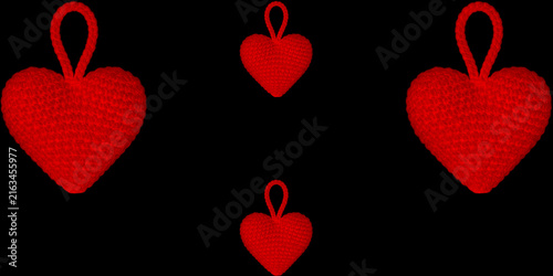 Four red crocheted heart ornaments with hanging loops arranged on a black background