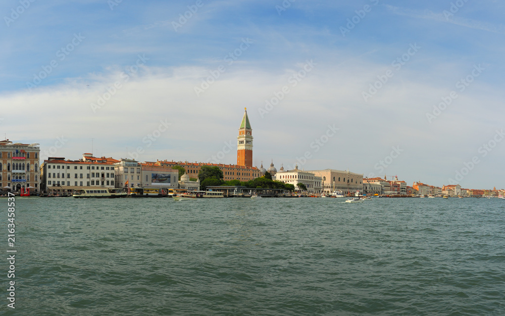 Fototapeta premium Scenic view of Venice waterfront with historic buildings, Campanile bell tower and Doge's palace across the lagoon