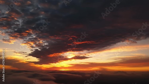 Dramatic sunset view over dense cloud cover.