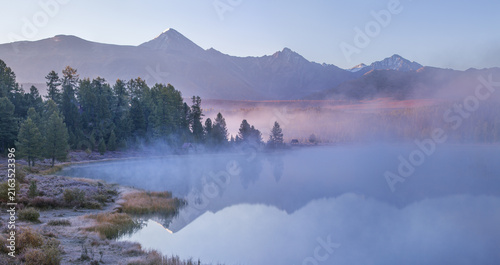 Mountain lake on an foggy morning, autumn landscape, forest