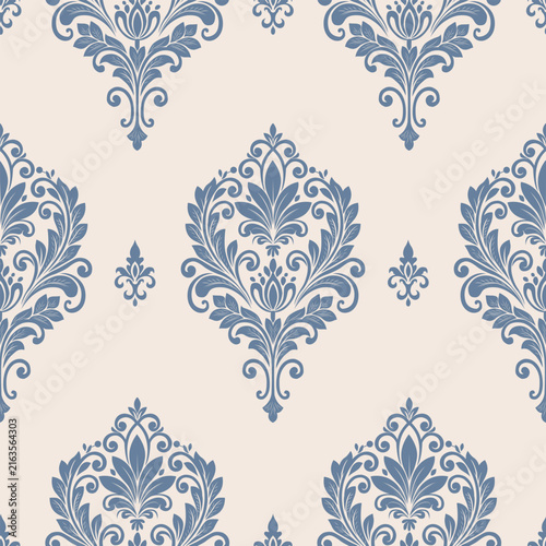 Elegant blue floral damask pattern on a soft beige background, featuring ornamental leaves, scrolling motifs, and classic vintage elegance for wallpaper and textile design.