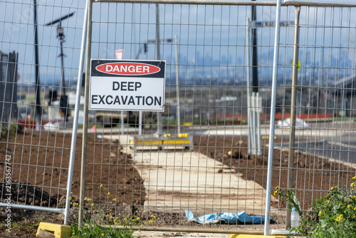 Photography A Danger Deep Excavation warning sign attached to temporary site fencing at a civil construction site in an outer suburb of Melbourne Australia