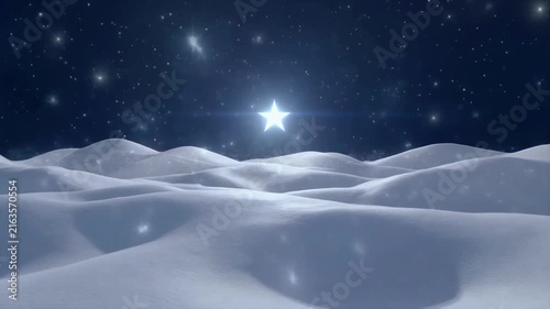 Bright shining star glows over snowy landscape in this beautiful holiday season winter motion video clip