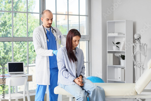 Healthcare and medical examination, doctor checking patients back in a clinic...