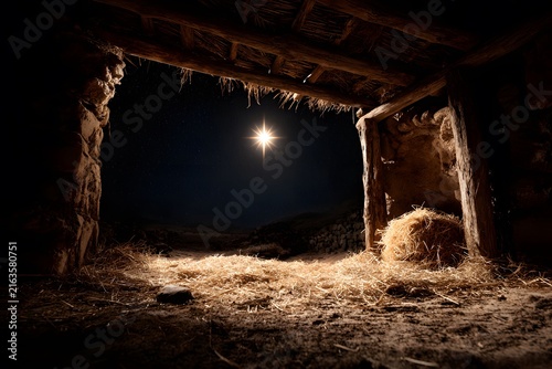 Star of bethlehem shining over a rustic wooden stable with straw on the ground at night
