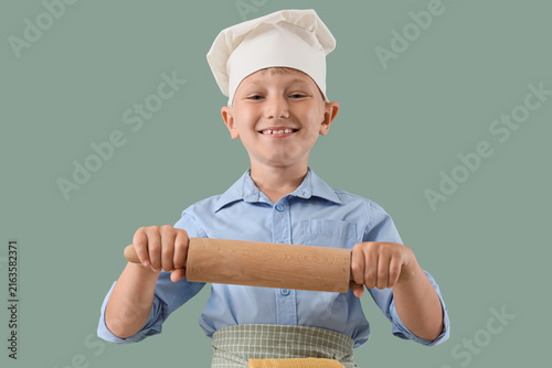 Cuadro en lienzo Childhood dreams of becoming a chef, happy boy in a bakers hat holding a rolling