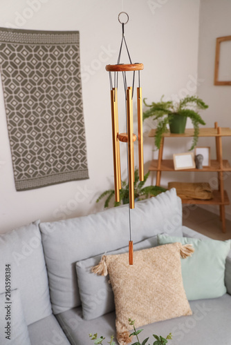 Fotografie Wind chime hanging in light living room, closeup