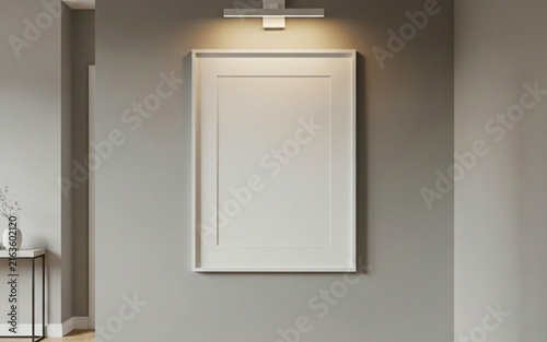 Vertical blank photo frame mockup on grey wall with wall lamp in modern minimalist interior design