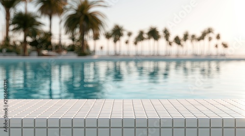 Sun-drenched resort pool, palm trees, and calm ocean create a serene tropical paradise