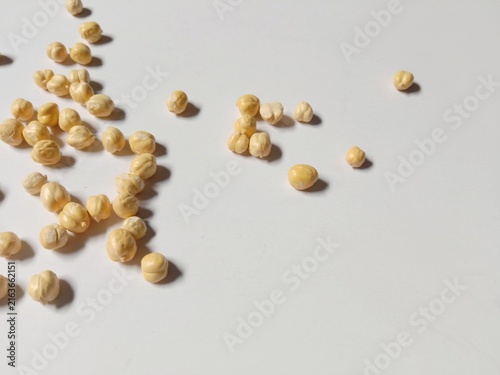 Dried Chickpeas Scattered on White Background with Natural Shadows