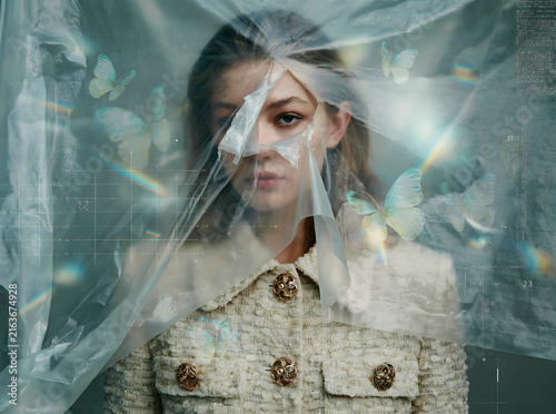 Conceptual portrait of a woman wrapped in clear plastic wrap, symbolizing vulnerability or isolation