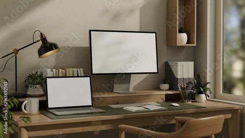 Cuadro en lienzo Computer monitor and laptop mockup with blank screens on wooden desk workspace 3