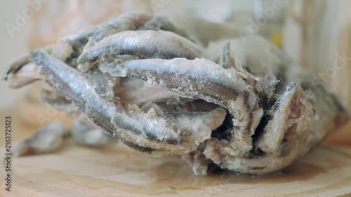 Frozen fish being prepared in a kitchen setting