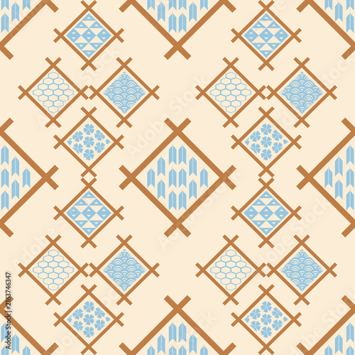 Traditional oriental Japanese motif of Uroko,seigaiha, Kozakura,Yagasuri seamless geometric graphic pattern in brown and light blue tones on cream background