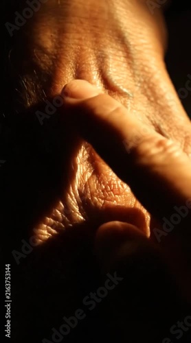 Extreme Close-Up of Elderly Hand Showing Deep Wrinkles and Veins Under Dramatic Lighting