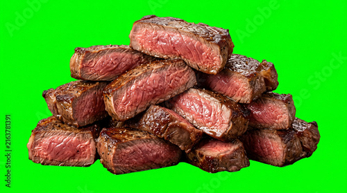 Medium cooked beef steak stacked, isolated on green screen background