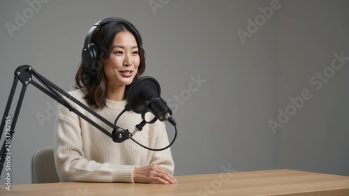 Asian woman recording a professional podcast in a studio